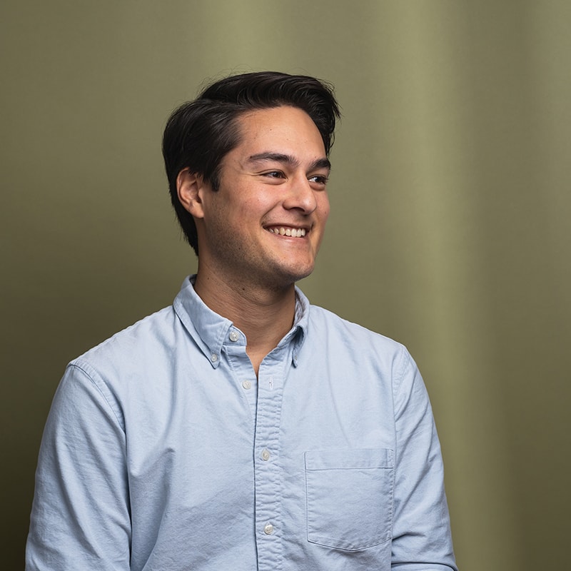 Headshot of Daniel Chen with green background