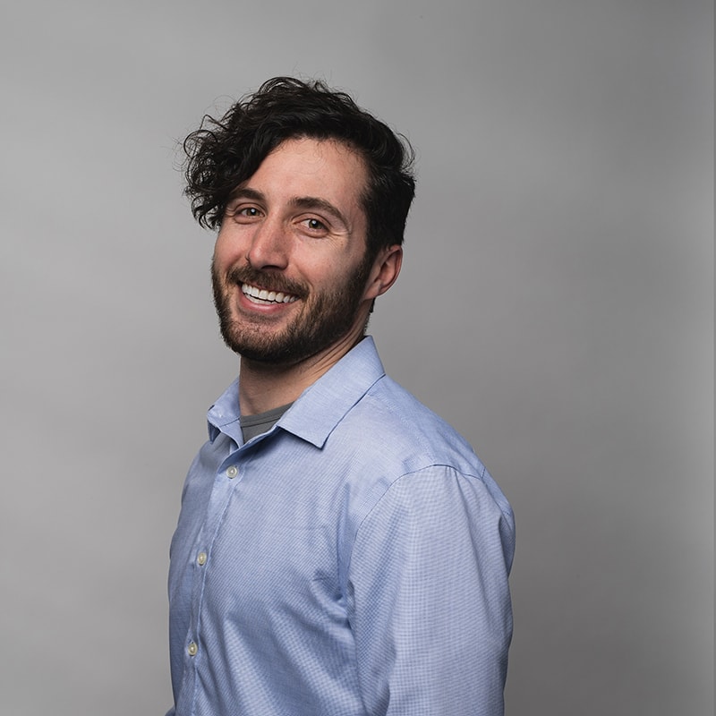 Headshot of Daniel Quartararo with dark gray background