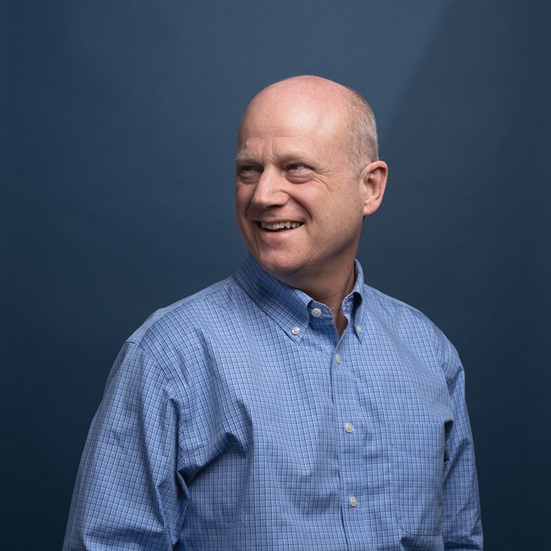 Headshot of Nick Weidemann with blue background